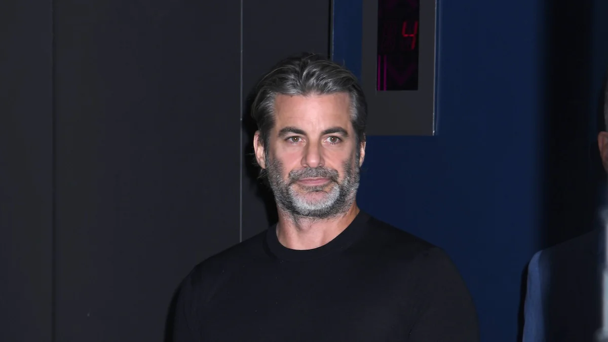 Jim Curtis im schwarzen Pullover vor dunklem Hintergrund